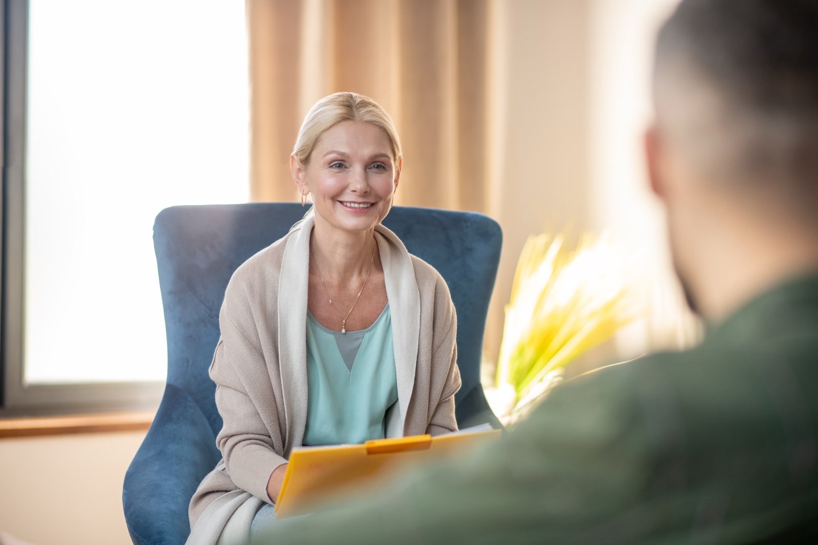 A woman smiling during a warm conversation with her therapist